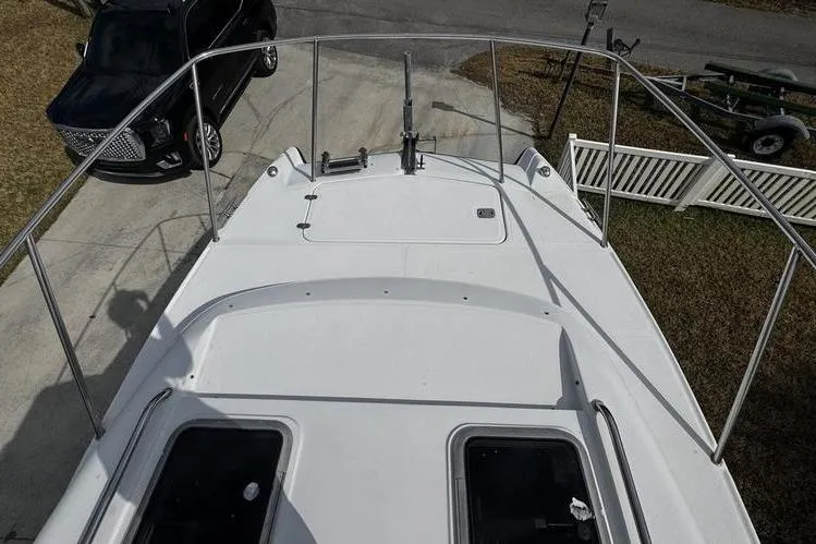 Slide: The Image of Top view of 2001 Glacier Bay 260 Canyon Runner boat docked near a black SUV. - 12