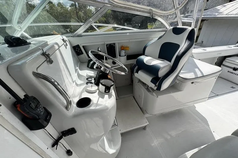 Slide: The Image of 2001 Glacier Bay 260 Canyon Runner boat cockpit with steering wheel and captain's chair. - 14
