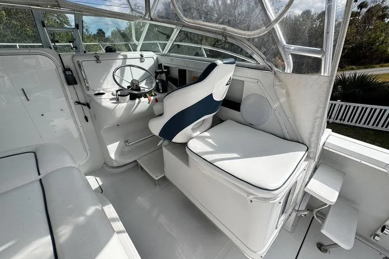 Slide: The Image of 2001 Glacier Bay 260 Canyon Runner boat cockpit with steering wheel and seating. - 16