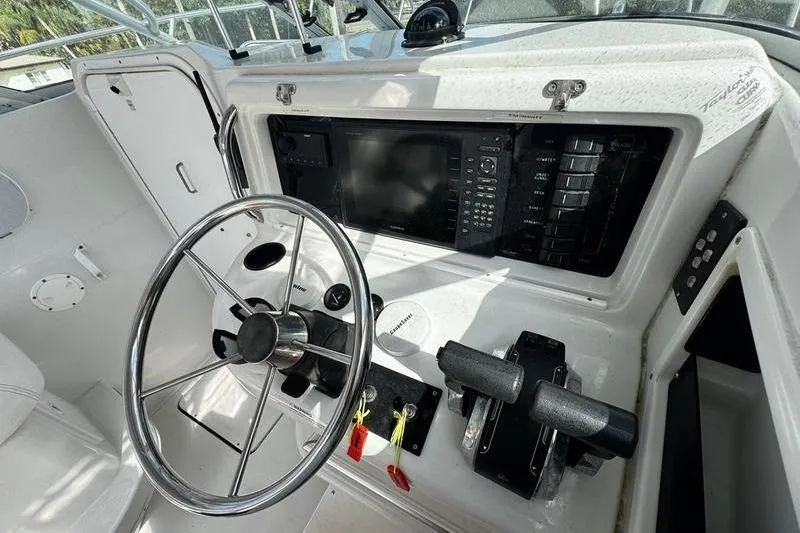 Slide: The Image of 2001 Glacier Bay 260 Canyon Runner boat helm with steering wheel and control panel. - 18