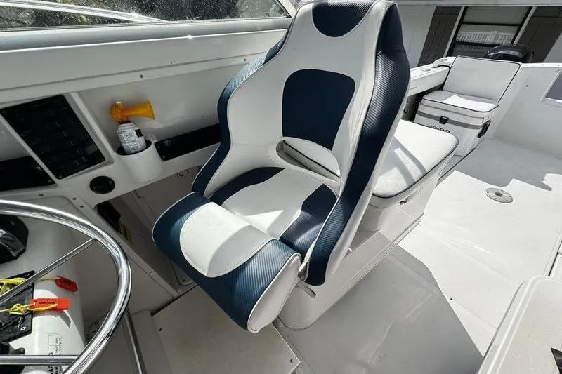 Slide: The Image of 2001 Glacier Bay 260 Canyon Runner boat interior with blue and white seating. - 20