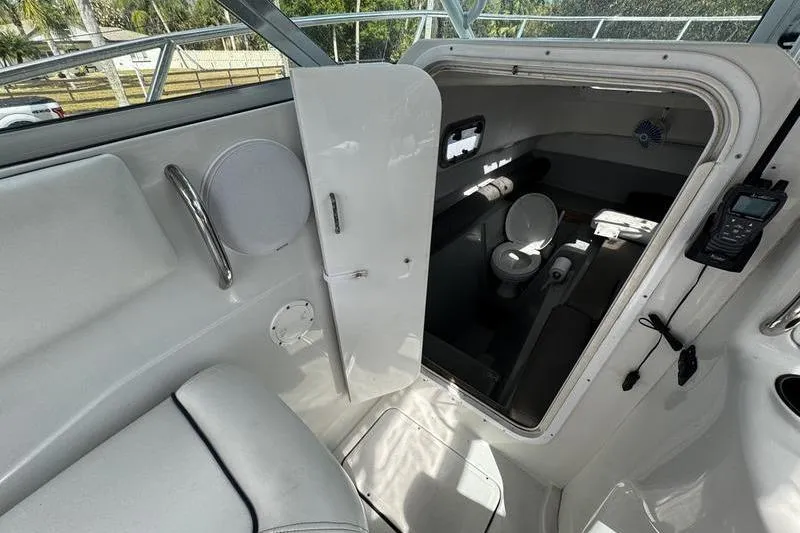 Slide: The Image of Interior view of 2001 Glacier Bay 260 Canyon Runner boat cabin with toilet. - 22