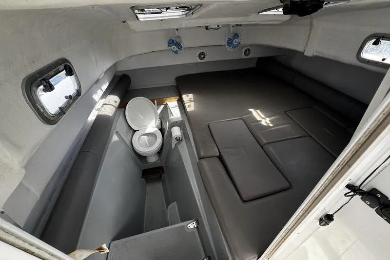 Slide: The Image of 2001 Glacier Bay 260 Canyon Runner cabin interior with bed and toilet. - 26