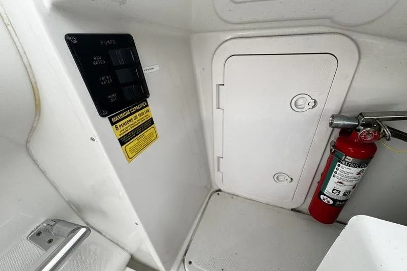Slide: The Image of 2001 Glacier Bay 260 Canyon Runner interior with control panel and fire extinguisher. - 27