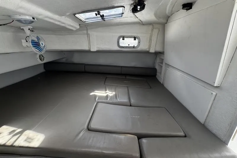 Slide: The Image of Interior cabin of 2001 Glacier Bay 260 Canyon Runner boat, featuring cushioned seating and ventilation. - 28