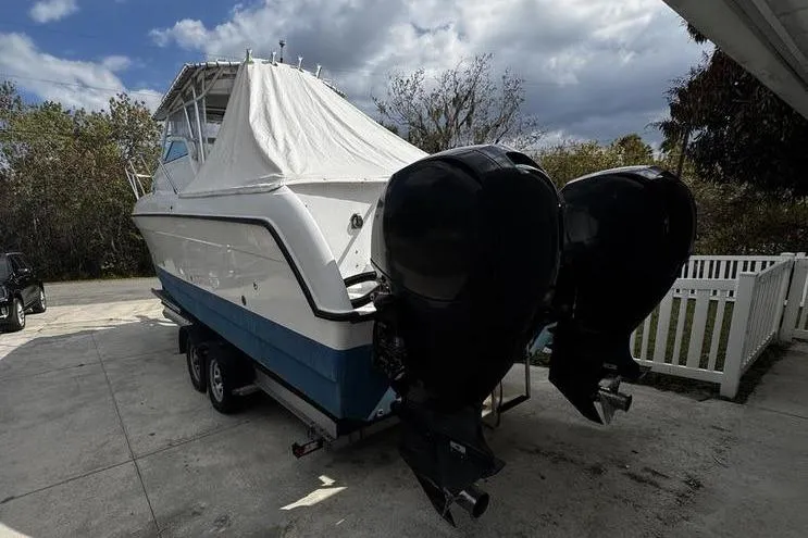 Slide: The Image of 2001 Glacier Bay 260 Canyon Runner boat with dual outboard motors on a trailer. - 3
