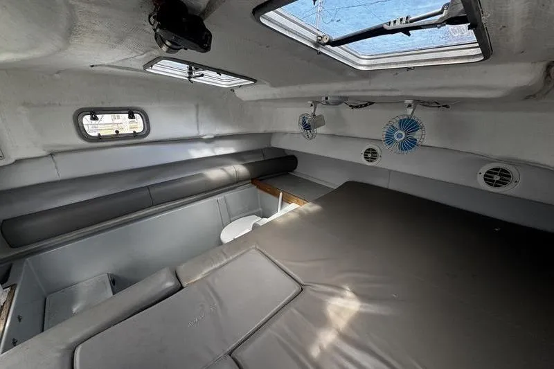 Slide: The Image of Interior cabin of 2001 Glacier Bay 260 Canyon Runner boat, featuring seating and fans. - 30