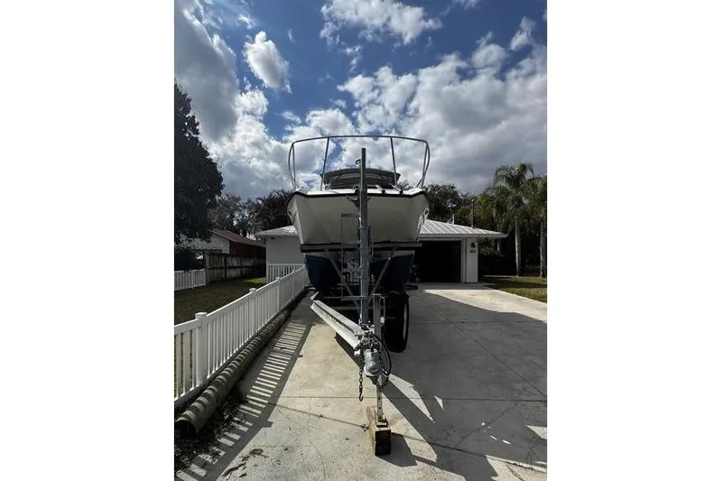 Slide: The Image of 2001 Glacier Bay 260 Canyon Runner boat on trailer under cloudy sky. - 4