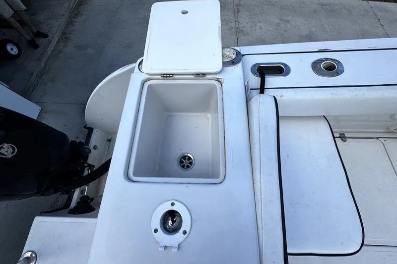 Slide: The Image of 2001 Glacier Bay 260 Canyon Runner boat deck with storage compartment and motor. - 50