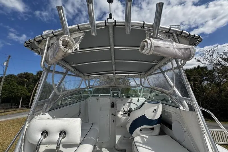 Slide: The Image of 2001 Glacier Bay 260 Canyon Runner boat interior with steering wheel and seating under canopy. - 9