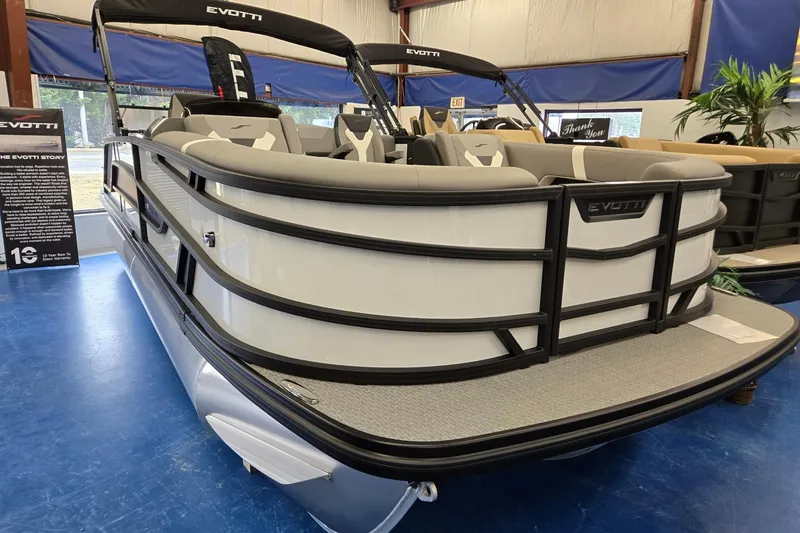 Slide: The Image of 2026 Evotti 521CS pontoon boat displayed indoors with sleek design and comfortable seating. - 0
