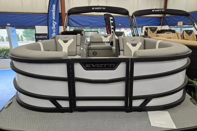 Slide: The Image of 2026 Evotti 521CS pontoon boat displayed indoors, featuring sleek design and comfortable seating. - 1