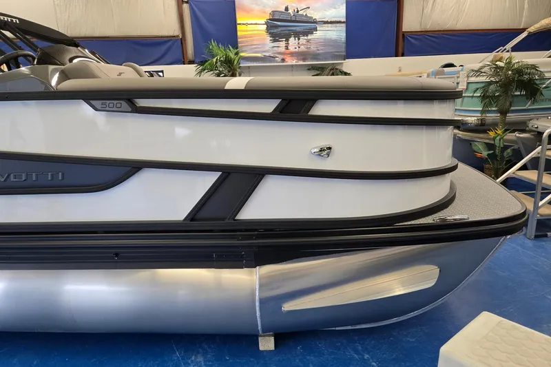 Slide: The Image of 2026 Evotti 521CS pontoon boat displayed indoors with sleek design and modern features. - 4