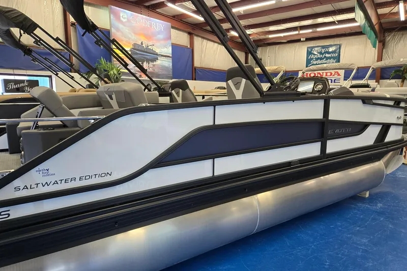 Slide: The Image of 2026 Evotti 521CS Saltwater Edition pontoon boat displayed indoors. - 5