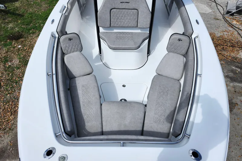Slide: The Image of 2022 Sea Pro 259 Deep V CC boat interior with gray cushioned seating. - 10