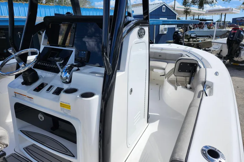 Slide: The Image of 2022 Sea Pro 259 Deep V CC boat interior with steering console and seating area. - 12