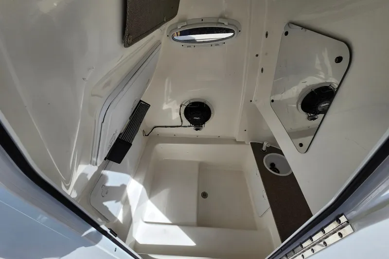 Slide: The Image of Interior cabin of 2022 Sea Pro 259 Deep V CC boat, featuring speakers and storage. - 13