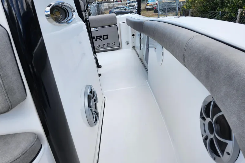 Slide: The Image of 2022 Sea Pro 259 Deep V CC boat interior with cushioned seating and speakers. - 21