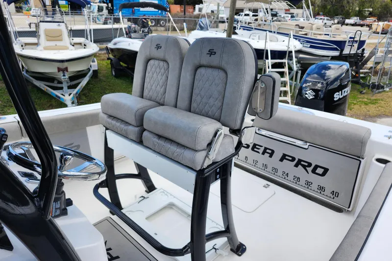 Slide: The Image of 2022 Sea Pro 259 Deep V CC boat interior with dual seats and steering wheel. - 22
