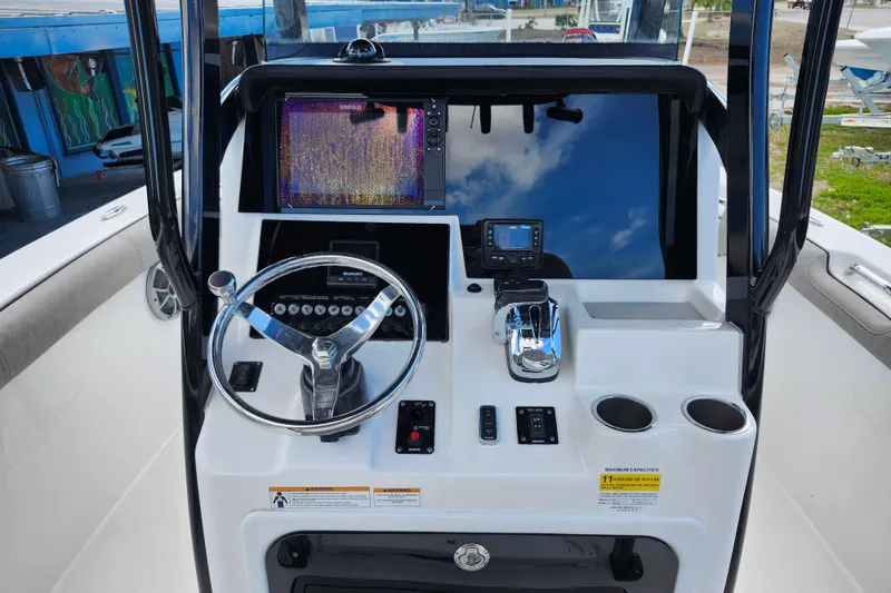 Slide: The Image of 2022 Sea Pro 259 Deep V CC boat console with steering wheel and navigation display. - 23