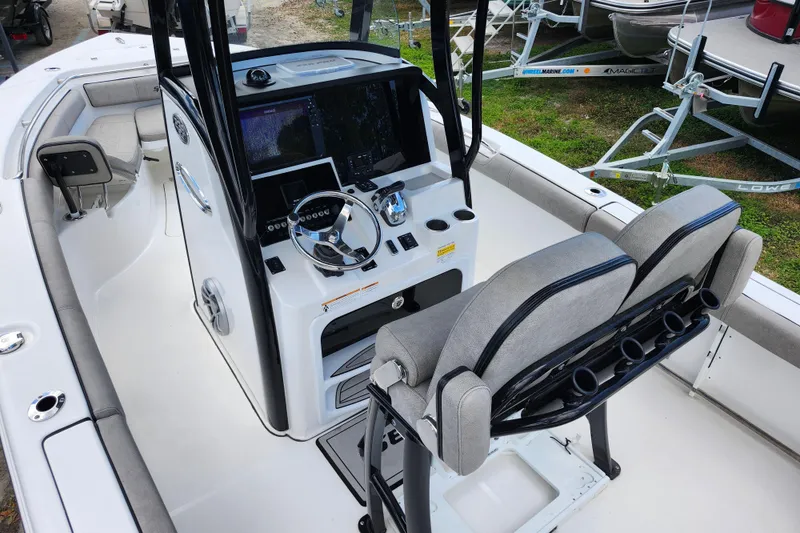Slide: The Image of 2022 Sea Pro 259 Deep V CC boat interior with helm, seating, and navigation equipment. - 25