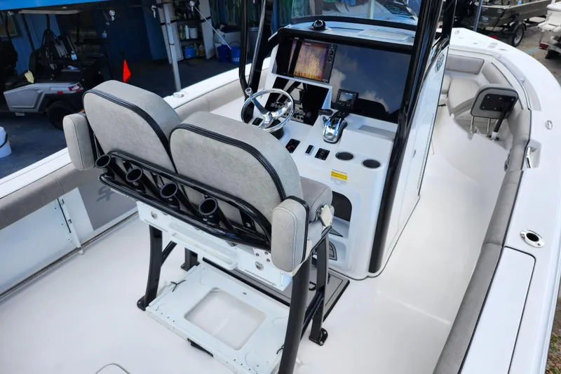 Slide: The Image of 2022 Sea Pro 259 Deep V CC boat interior with helm, seating, and navigation equipment. - 26