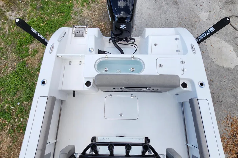 Slide: The Image of 2022 Sea Pro 259 Deep V CC boat interior with seating, storage, and motor. - 29