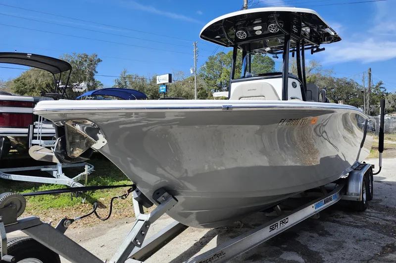 Slide: The Image of 2022 Sea Pro 259 Deep V CC boat on trailer under clear blue sky. - 3