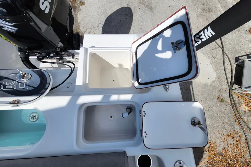 Slide: The Image of 2022 Sea Pro 259 Deep V CC boat with open storage compartments and engine view. - 36