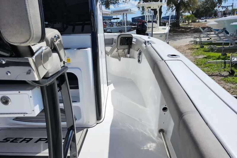 Slide: The Image of 2022 Sea Pro 259 Deep V CC boat interior with seating and console view. - 43