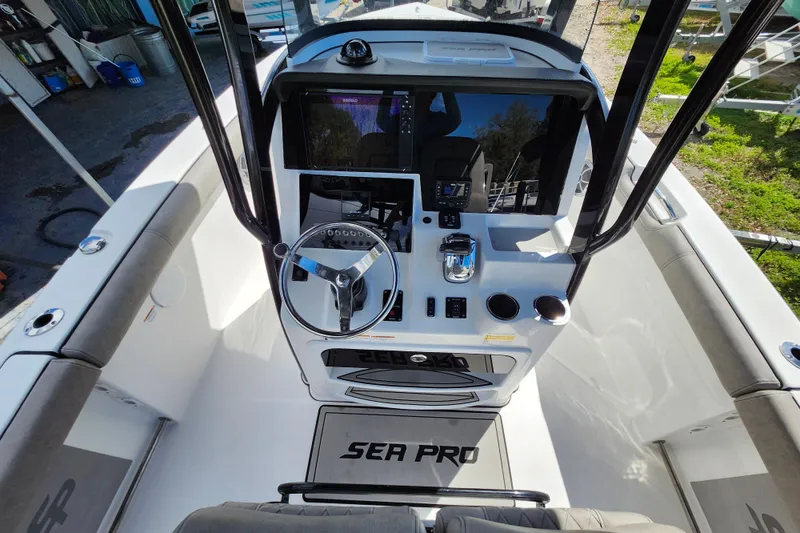 Slide: The Image of 2022 Sea Pro 259 Deep V CC boat console with steering wheel and controls. - 46