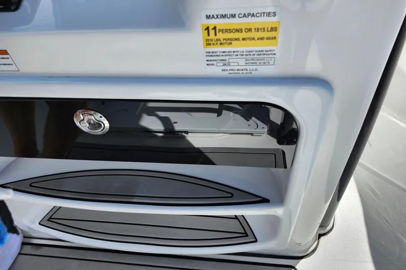 Slide: The Image of 2022 Sea Pro 259 Deep V CC boat storage compartment with capacity label. - 48