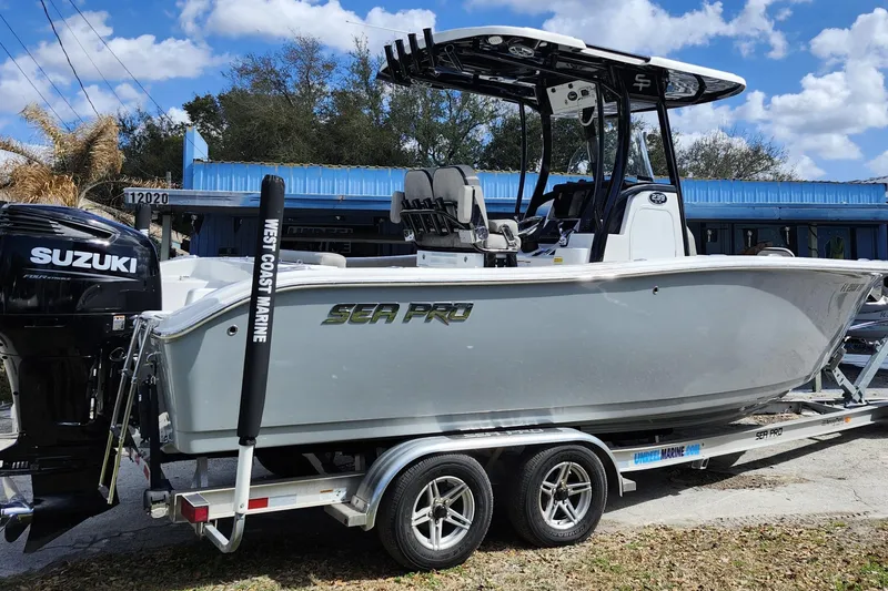 Slide: The Image of 2022 Sea Pro 259 Deep V CC boat on trailer with Suzuki engine, outdoors. - 6
