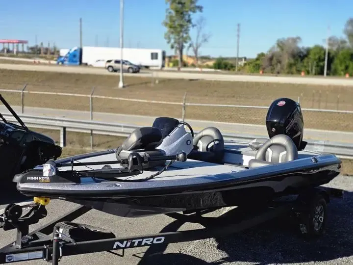 Slide: The Image of 2026 Nitro Z17 boat on trailer, parked beside road. - 2
