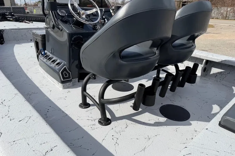 Slide: The Image of 2025 Haynie 23 Magnum boat interior with dual seats and rod holders. - 11