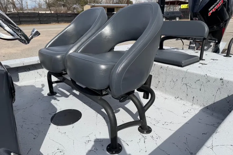 Slide: The Image of 2025 Haynie 23 Magnum boat interior with dual gray seats and sturdy metal frames. - 12