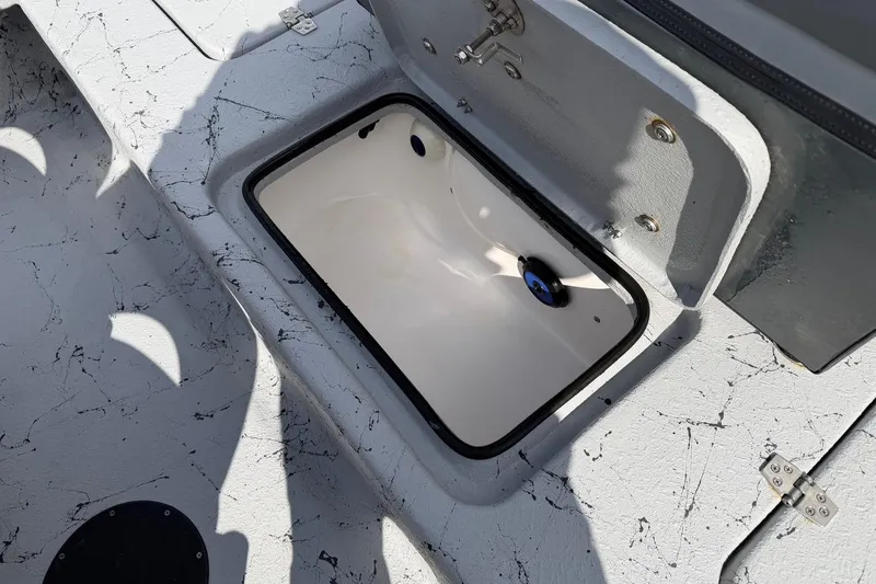 Slide: The Image of Open storage compartment on 2025 Haynie 23 Magnum boat with textured surface. - 17