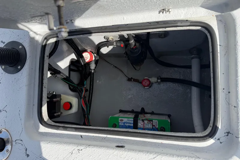 Slide: The Image of 2025 Haynie 23 Magnum boat compartment with battery and wiring components. - 18