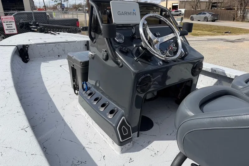 Slide: The Image of 2025 Haynie 23 Magnum boat interior with Garmin navigation and sleek steering console. - 9