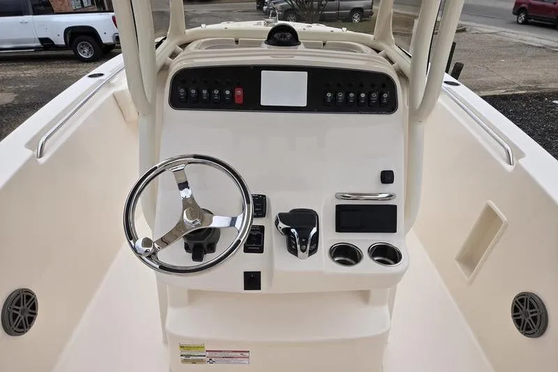 Slide: The Image of 2026 Grady-White Fisherman 236 boat console with steering wheel and controls. - 13