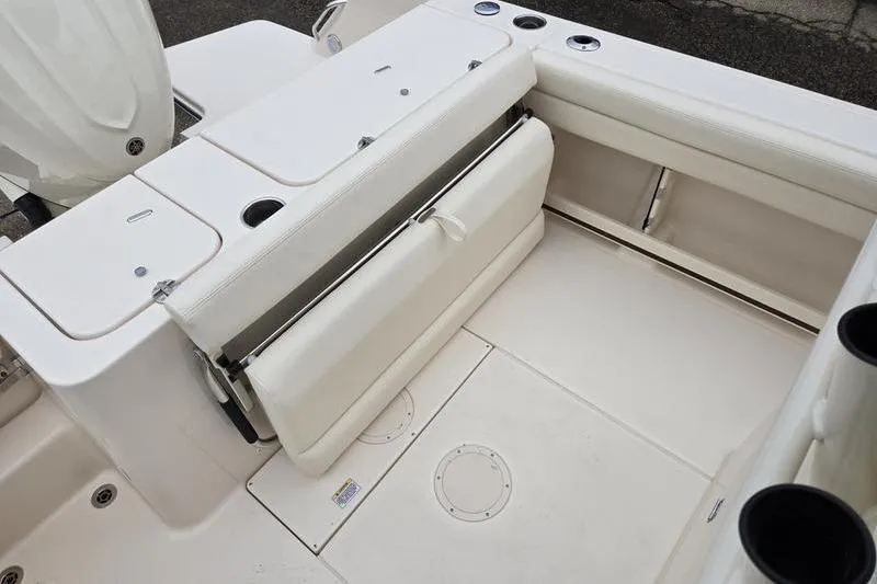 Slide: The Image of 2026 Grady-White Fisherman 236 boat interior with foldable seating and storage compartments. - 8