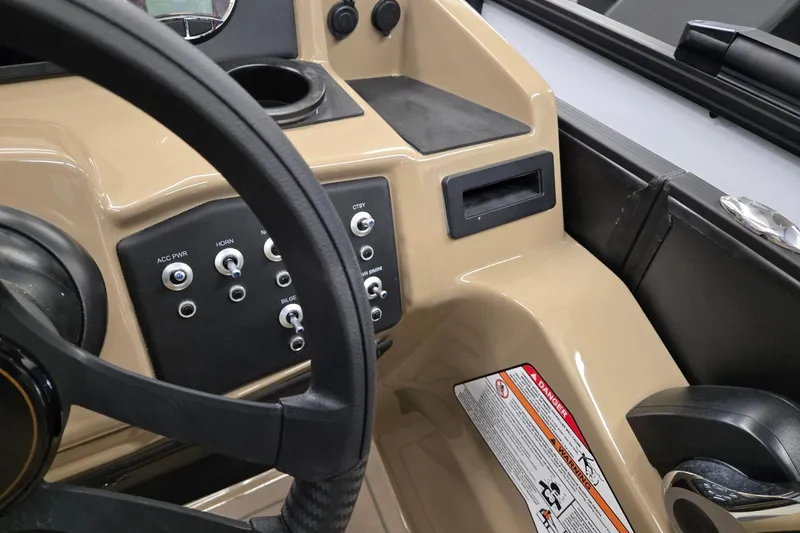 Slide: The Image of Dashboard of 2026 Evotti 521QL boat with control switches and steering wheel. - 13