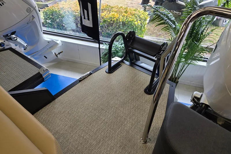 Slide: The Image of Evotti 521QL 2026 boat interior with carpeted deck and railing. - 19