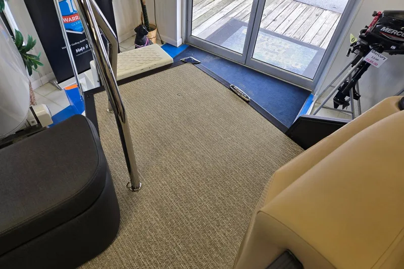 Slide: The Image of Interior of 2026 Evotti 521QL boat with carpeted floor and chrome railing. - 21