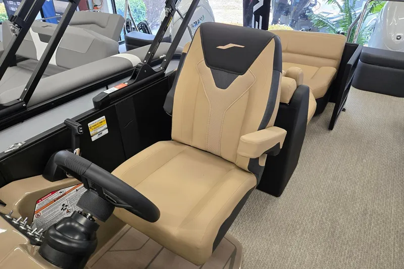 Slide: The Image of 2026 Evotti 521QL boat interior with beige captain's chair and steering wheel. - 9