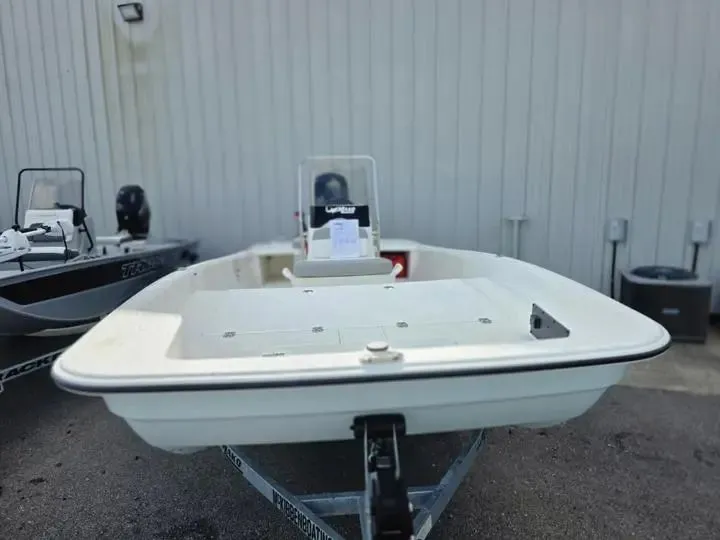 Slide: The Image of 2026 Mako Pro Skiff 17 CC on trailer outside building. - 9