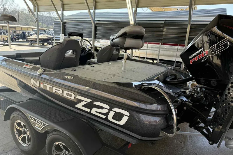 Slide: The Image of 2023 Nitro Z20 Pro fishing boat with Mercury Pro XS engine in a covered area. - 2