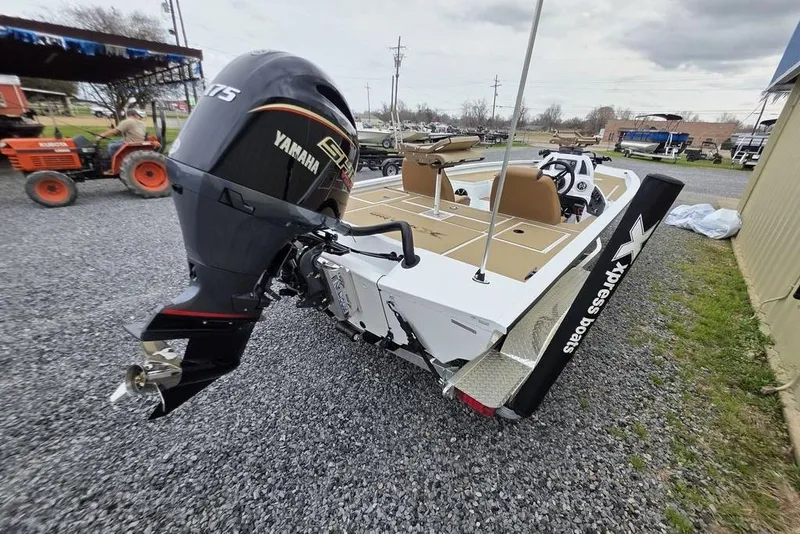 Slide: The Image of 2026 Xpress H20CC boat with Yamaha motor on gravel lot. - 12