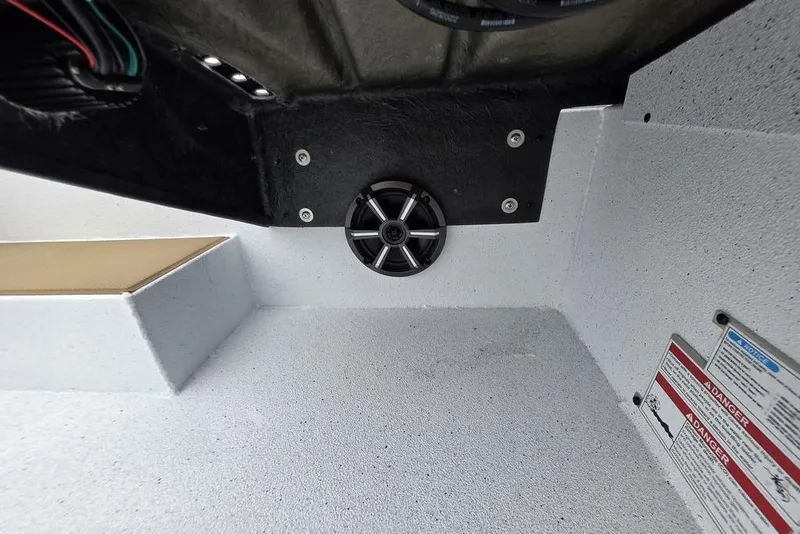 Slide: The Image of Interior view of 2026 Xpress H20CC boat featuring speaker and warning labels. - 14