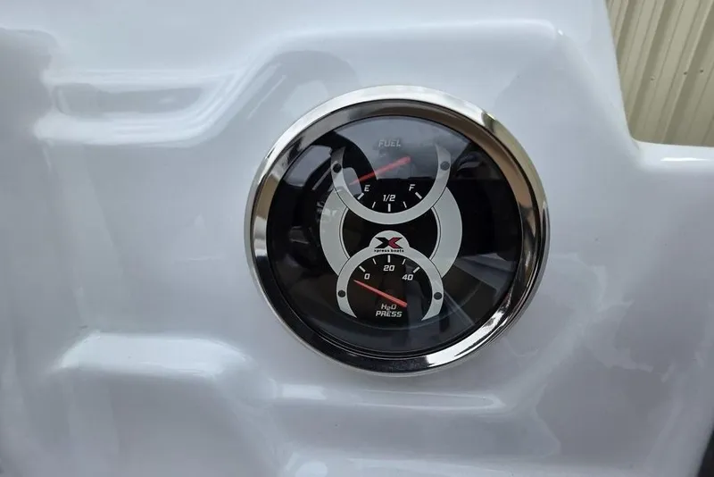 Slide: The Image of Dashboard gauges of 2026 Xpress H20CC boat, showing fuel and water pressure levels. - 16